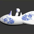 White Airplane Shaped Decorative Ornament With Blue Floral Patterns Purple Seat And Small Pilot Figure