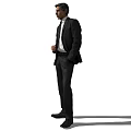 Man In Black Suit Standing With Black Tie And Hand In Pocket