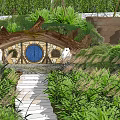 Hobbit Style Residential House With Round Blue Door And Circular Windows In Lush Green Forest