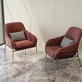 Burgundy Ribbed Accent Chairs With Gold Metal Legs And Plaid Cushions On Marble Floor