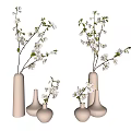 White Ceramic Vases Adorned With White Blossoms And Green Leaves On Light Background