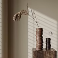 Brown And Black Spiral Vases With Dried Plants On Wooden Stand And Window Blind Shadows