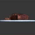 Freshly Baked Banana Bread with Slices on White Ceramic Plate