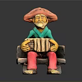 Colorful Clay Statue of Man in Hat Sitting on Bench Playing Accordion