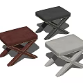 Three Colored Upholstered Stools In Red Black White With Cross Legged Design And Rivet Details