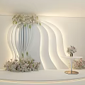 Elegant Wedding Decor With White Curved Backdrop Floral Arrangements And Small Round Table