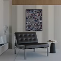 Modern Leather Leisure Chair with Button Tufting Against Vertical Striped Wall and Abstract Painting