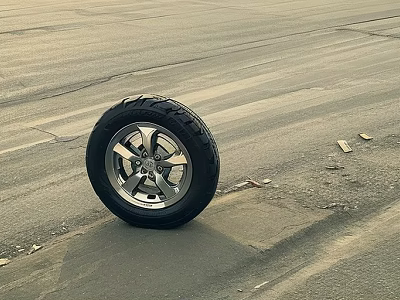 Motorcycle Tire With Silver Rim And Black Tread On Empty Asphalt Ground 3d model