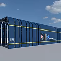 Blue Mobile Building With Yellow Stripes And VANDA Logo Near Trees Under Blue Sky