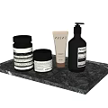 Daily Cleaning Products Including Pump Bottle Jars And Tube On Black Marble Tray