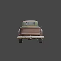 Rusty Old Truck Parked on Asphalt Road Against Mountainous Landscape and Cloudy Sky