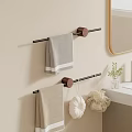 Gray And Beige Soft Towels On Black Towel Rack With Wooden Ends In Bathroom