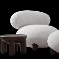 Plush White Rounded Lounger With Wooden Side Table And Cylindrical Legs