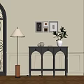 Gray Console Table Side Cabinet Decorative Frames Green Plant Vase Floor Lamp on Elegant Wall