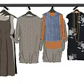 Clothes Hangers With Various Dresses Tops Vests And Skirts Hanging On Rail