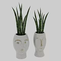 Two White Ceramic Face Shaped Vases With Green Striped Indoor Plants
