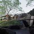 Modern Garden Landscape With Circular Water Feature Trees And Grassy Mounds