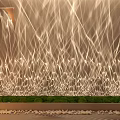 Elegant Strand Decorative Lights Creating Wall Art With Green Grass And Pebbles