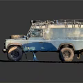 Vintage Blue Silver Off Road Vehicle With Roof Rack Front Spare Tire On Stone Pavement