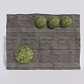 Gray Stone Feature Wall Decorated With Three Small And One Large Green Topiary Balls