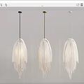 Modern White Fringed Pendant Lights With Black Gold White Cords Against Gray Wall
