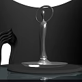 Silver Human Sculpture With Circular Halo Top On Round Base Surrounded By Curved Wall Art