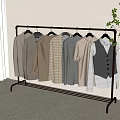 Stylish Neutral Tones Clothing Items On Metal Rack In Minimalist Room With Plant
