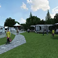 Scenic Garden Landscape Featuring RVs Green Lawn Stone Path Trees and People
