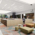 Modern Front Desk Reception Area With Sofa Seating People And Colorful Floor Tiles Near Supermarket