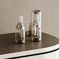 Transparent Glass Cups Three Different Shapes on Dark Round Tabletop with Light Colored Wall Background