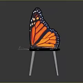Butterfly Shaped Chair With Orange Black Wings And Metal Legs Design