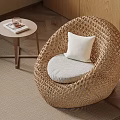Cozy Wicker Chair With White Cushion Small Round Table On Beige Rug And Wooden Wall