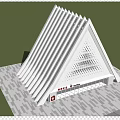 White Triangle Shaped Building With Hollowed Out Design And Red Signage Surrounded By Trees