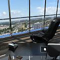 Black Ergonomic Office Chair In Modern Office With Large Windows And City View