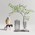 Glass Vase with Green Leafy Branch and Decorative Figure on Tabletop