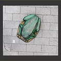 Green Reptile Sculpture On Gray Stone Paved Surface With Wooden Base