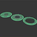 Three Black Circular Mechanical Components With Central Holes And Raised Edges
