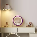 Dressing Table Featuring Purple Rimmed Round Mirror With Stand And Cosmetics Organizer Under Soft Lighting