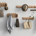 Stylish Wooden Wall Hooks on White Wall with Handbags Hat Towel and Plants