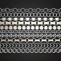 Various Decorative Metal Chain And Hexagonal Circular Patterns Arranged Neatly On Black Background