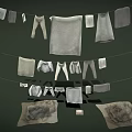 Light Gray Apparel Hanging on Ropes Including Pants Towels and Tops