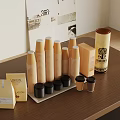 Stacked Brown Paper Cups With Small Boxes Cylindrical Canisters And Black Lids On Table