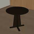 Black Round Side Table With Smooth Surface On Wooden Floor And Cabinet Background