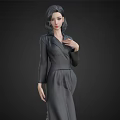 Elegant Woman in Dark Gray Tailored Dress with Dark Hair Against Black Background