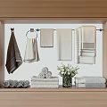 Colored Towels in Wooden Frame Display Hanging Rod with Rolled Stacked and White Flower Vase