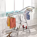 Sturdy Metal Foldable Clothes Drying Rack With Hanging Clothes And Shoes Near Window