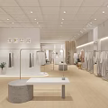 Modern Clothing Store Interior With Clothing Racks Mannequins Sofa And Green Plants