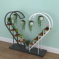 Heart Shaped Black And White Shelving Unit With Hanging Plants And Potted Greenery