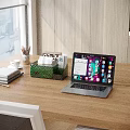 Daily Necessities On Wooden Tabletop With Tissue Box Pencil Holder And Laptop