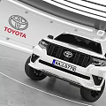 Toyota White SUV With Black Wheels Displayed In Modern Showroom Interior